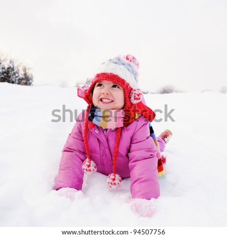 Little girl playing in snow