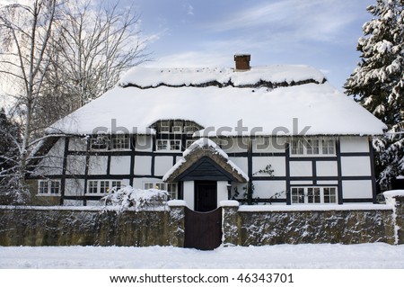 Traditional English thatch cottage in snow