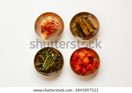 The most famous Korean food Kimchi set(napa cabbage, leaf mustard, turnip, leek kimchi ) in high quality brass tableware. Isolated on white background. Top view. 
