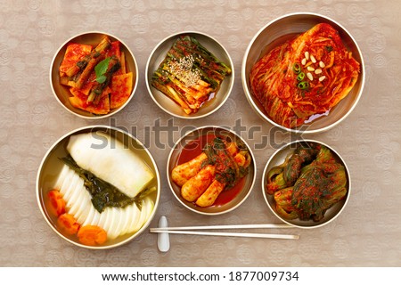 The most famous Korean food Kimchi set(napa cabbage, leaf mustard, turnip, green onion, whole radish, radish water ) in high quality brass tableware. Top view.  
