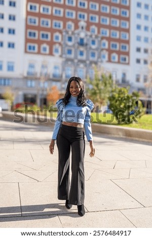 Similar – Foto Bild Elegante ethnische Geschäftsfrau zu Fuß in der Innenstadt mit Tasse Kaffee