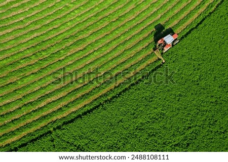 Similar – Image, Stock Photo Farm field is planted with agricultural plants. Watering the crop. Agro industry, agribusiness. Farming, european farmland. Traditional irrigation system. Growing and producing food. Rural countryside