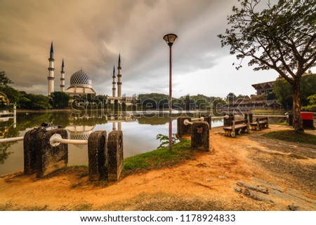 a beautiful view of Sultan Salahuddin Abd Aziz Mosque with reflection from the lake during sunrise