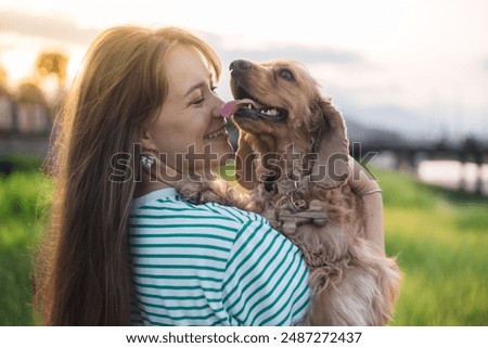 Similar – Image, Stock Photo young woman kissing her dog outdoors in a park with a lake. sunny day, autumn season