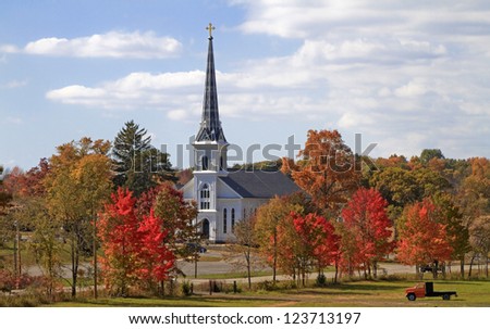 Country Church -- A small Catholic Church stands amid the changing colors of the trees -- Parnell, Michigan.