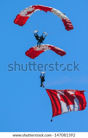 BAGOTVILLE, QUEBEC/CANADA  - JUNE 22: Bagotville Airshow. The Canadian Forces Skyhawks Parachute Team doing figures in Bagotville, Quebec, Canada on June 22, 2013.