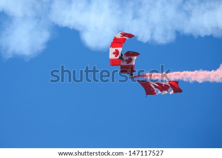 BAGOTVILLE, QUEBEC/CANADA  - JUNE 22: Bagotville Airshow. The Canadian Forces Skyhawks Parachute Team doing figures with smoke in Bagotville, Quebec, Canada on June 22, 2013.