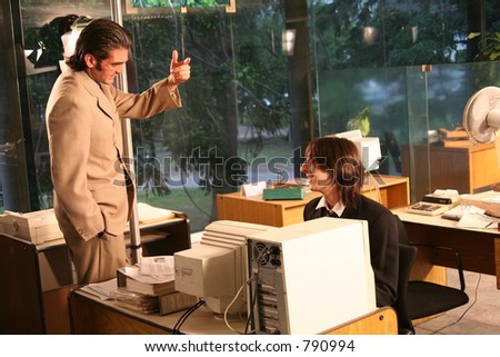Office Man talking to his manager on a movie set