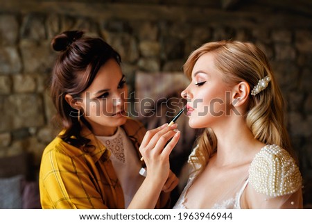 Similar – Image, Stock Photo Makeup artist doing makeup for young female artist