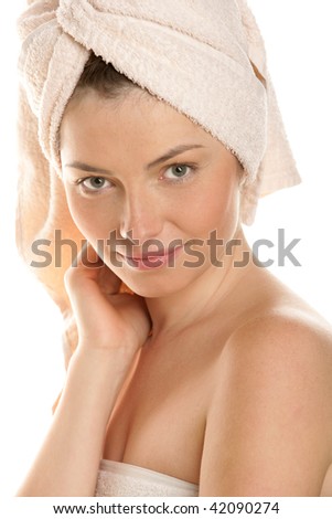 Portrait of happy woman wrapped towel isolated on white background
