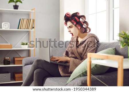 Funny shocked flabbergasted woman opens mouth and gasps in surprise looking at laptop computer. Young lady gets amazing news, wins present online or envies other more successful people on social media Stock foto © 