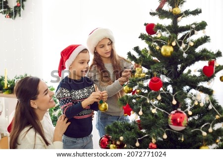 Similar – Image, Stock Photo Boy decorating Christmas tree in evening