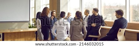Business coach meeting with group of people in modern office interior. Team of workers listening to teacher's inspirational speech during creative business training class. Banner, header background Zdjęcia stock © 