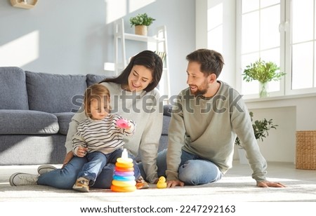 Similar – Image, Stock Photo Young parents playing with their child at home