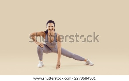 Similar – Image, Stock Photo Happy woman stretching legs during yoga class with trainer