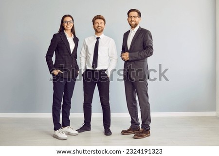 Similar – Image, Stock Photo Three people and a dog walk a dam wall under a hazy autumn sunset