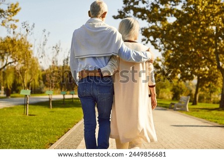 Similar – Image, Stock Photo A man walks through the green forest