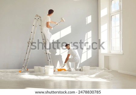 Image, Stock Photo Renovation concept. Male worker plastering a wall using a long spatula