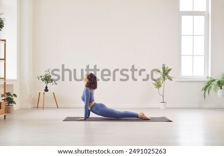 Similar – Image, Stock Photo attractive woman doing yoga stretching on alfonbrilla with copy space for advertising