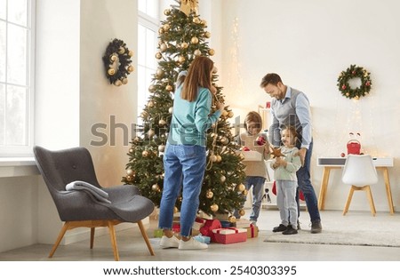 Image, Stock Photo Child decorating the tree seen from behind