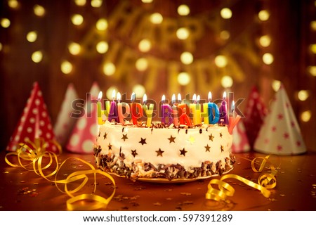 Happy Birthday Cake With Candles On The Background Of Garlands A