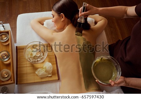 Similar – Image, Stock Photo Relaxed woman applies mineral clay mask on face for rejuvenation, has headband on head
