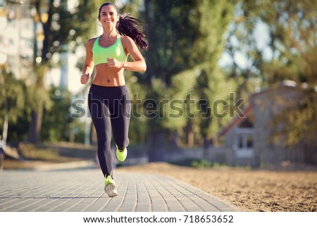 Image, Stock Photo Young brunette Woman running on asphalt road in summer park. Active sporty caucasian female has morning workout. Athletic person in sportswear exercises outdoor. Dressed leggings and sportive top