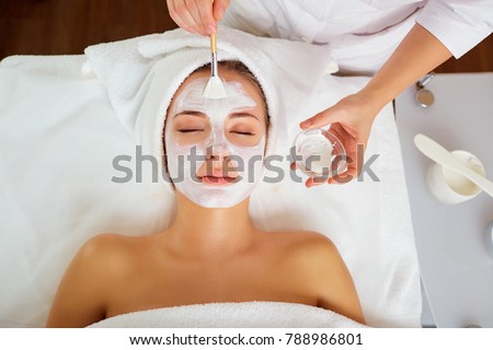 Similar – Image, Stock Photo Relaxed woman applies mineral clay mask on face for rejuvenation, has headband on head