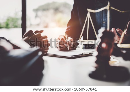 Business woman and lawyers discussing contract papers with brass scale on wooden desk in office. Law, legal services, advice, Justice concept. 商業照片 © 