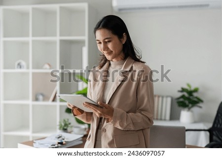 Similar – Image, Stock Photo Young businesswoman using digital tablet in her office