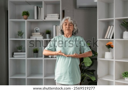 Similar – Image, Stock Photo Focused Senior Woman Practicing Yoga With Hands Clasped