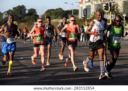 DURBAN, SOUTH AFRICA â?? MAY 31: Russian twins trail race leader Caroline Wostmann as they run through Hillcrest in the 2015 Comrades marathon Up run in Kwa Zulu Natal, South Africa on May 31, 2015.