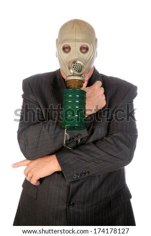 A professional Business Man in a Grey Pin Stripe Suit, wears a green Gas Mask representing, Global Warming, Corporate Greed, Pollution, Big Business, Industrial Waste, Toxic Waste and other concepts.