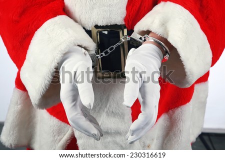 Santa in Hand Cuffs. Santa Claus has been a Bad Bad Boy this year. Perhaps he had one to many Brandy Alexander\'s or Too Many Cookies or went down the chimney of an Unbeliever and they called the cops.