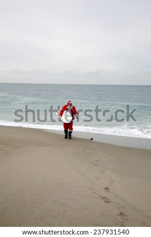 Surfing Santa Claus. A lonely Santa Claus walks on an empty beach with his Surfboard under his arm ready to go ride the waves alone. Reindeer and Elves do not surf so they leave Santa alone.