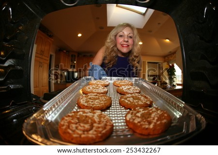 Hot and Fresh COOKIES right from the oven!  A lady bakes cookies for a charity bake sale to help raise money for a homeless dog rescue group