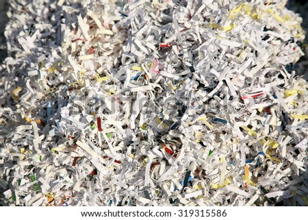 Confetti Shredded paper in a recycle trash can. The best way to keep safe from Identity Fraud is to confetti shred your important discarded documents. ID fraud is a rising form of theft world wide