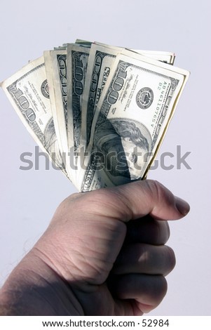 american cash being held tight in the fist of a real humanbeing against a white background