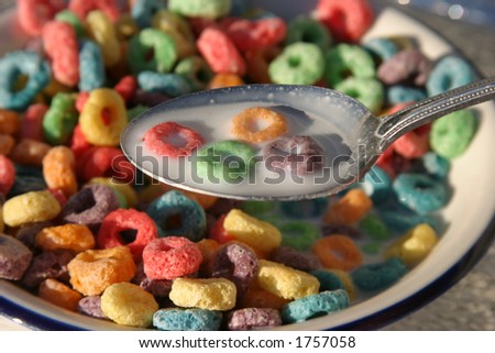 colorful cereal rings in milk on a spoon