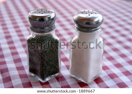 salt and pepper shakers on a red and white table cloth