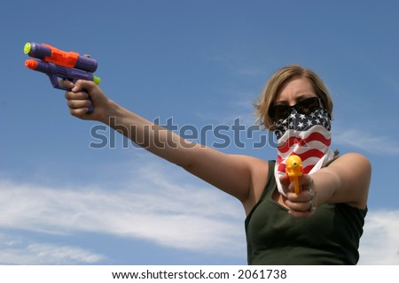 Girl with American Flag bandanna hold squirt guns at You and in the air