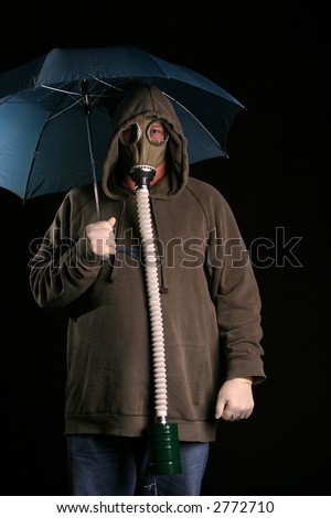 Apocalyptic acid rainy day A man in a gas mask holds a blue umbrella to protect himself from the acid rain in a futuristic nuclear wasteland