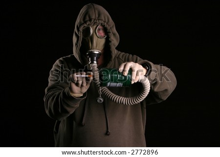 anti-smoking concept a man in a gas mask attempts to smoke a cigarette through the filter