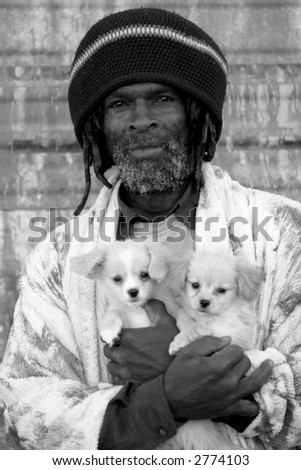 a colorful person poses for me to take his picture with his new puppies in black and white