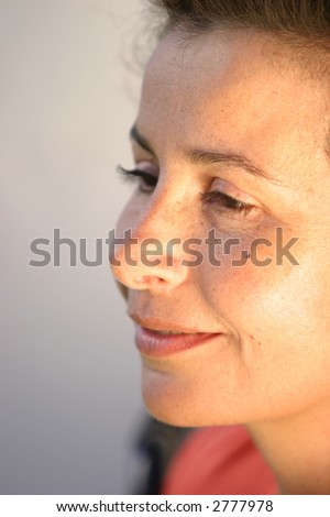 a classic looking woman looks down with room for text