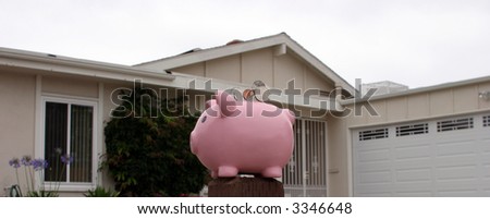 Saving for a home concept pink piggy bank in front of a house