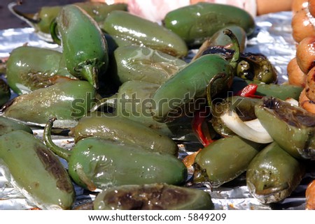 jalapeno chillies being cooked on a barbecue at an outdoor art show