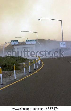 10-22-2007  Irvine California Arson Set Wild Fires fire and flames continue to devistate southern california in this photo series a freeway on ramp is engulfed in smoke