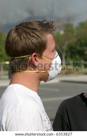 People wear paper masks, and bandannas to try to filter out the noxious curling black smoke from the Santiago Canyon wild fires