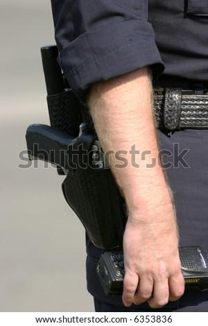 a close up of a police man holding his radio